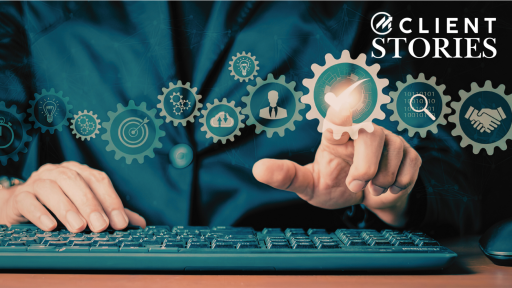Businessman at a keyboard choosing an automation from a line of connected gear icons.